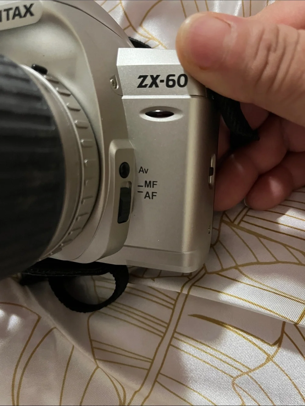 Pentax Silver and Black DSLR with 28-90mm Zoom Lens and Branded Strap